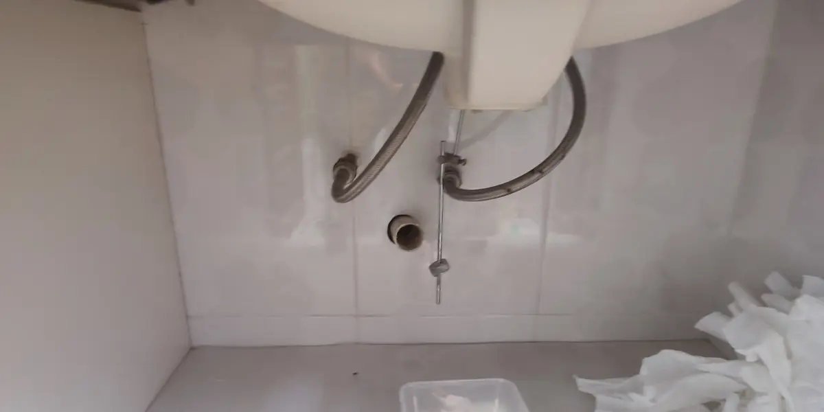Plumber repairing kitchen sink pipe in Puchong